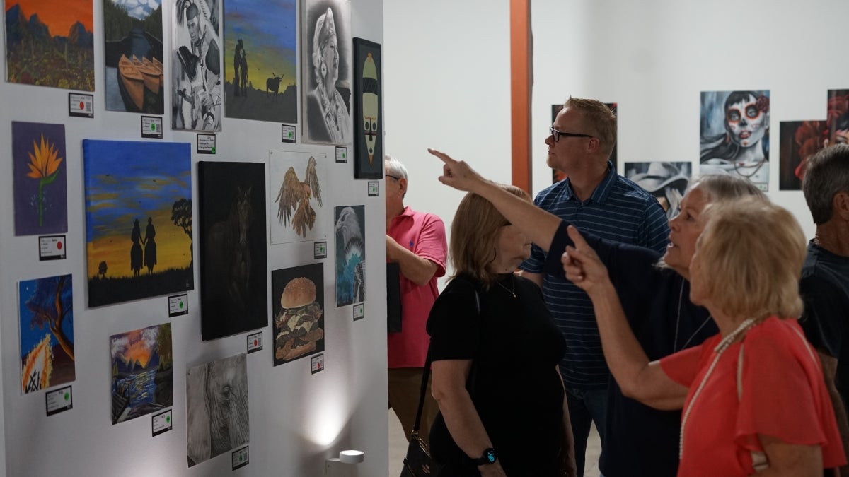 People gathered in an art gallery